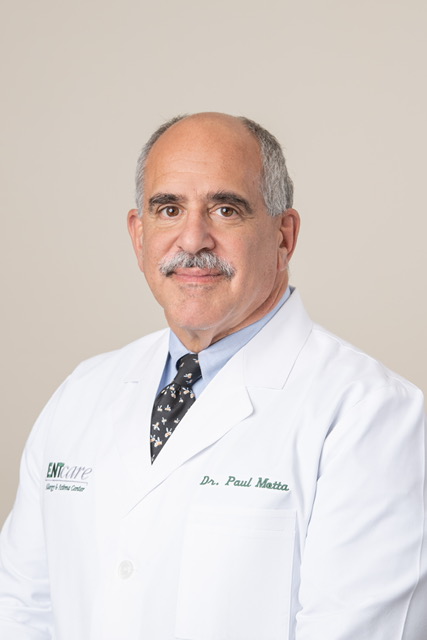 A man in a white lab coat from Dothan poses for a photo.